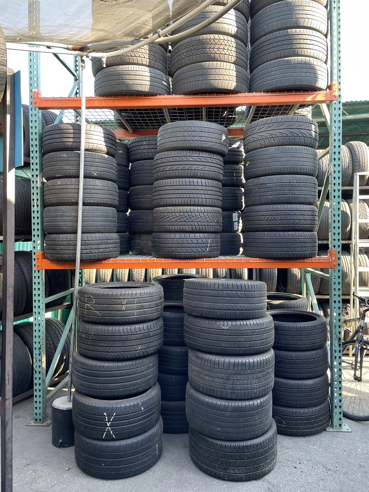 Racks stacked with new and used tires in all sizes at Rudy's Tires